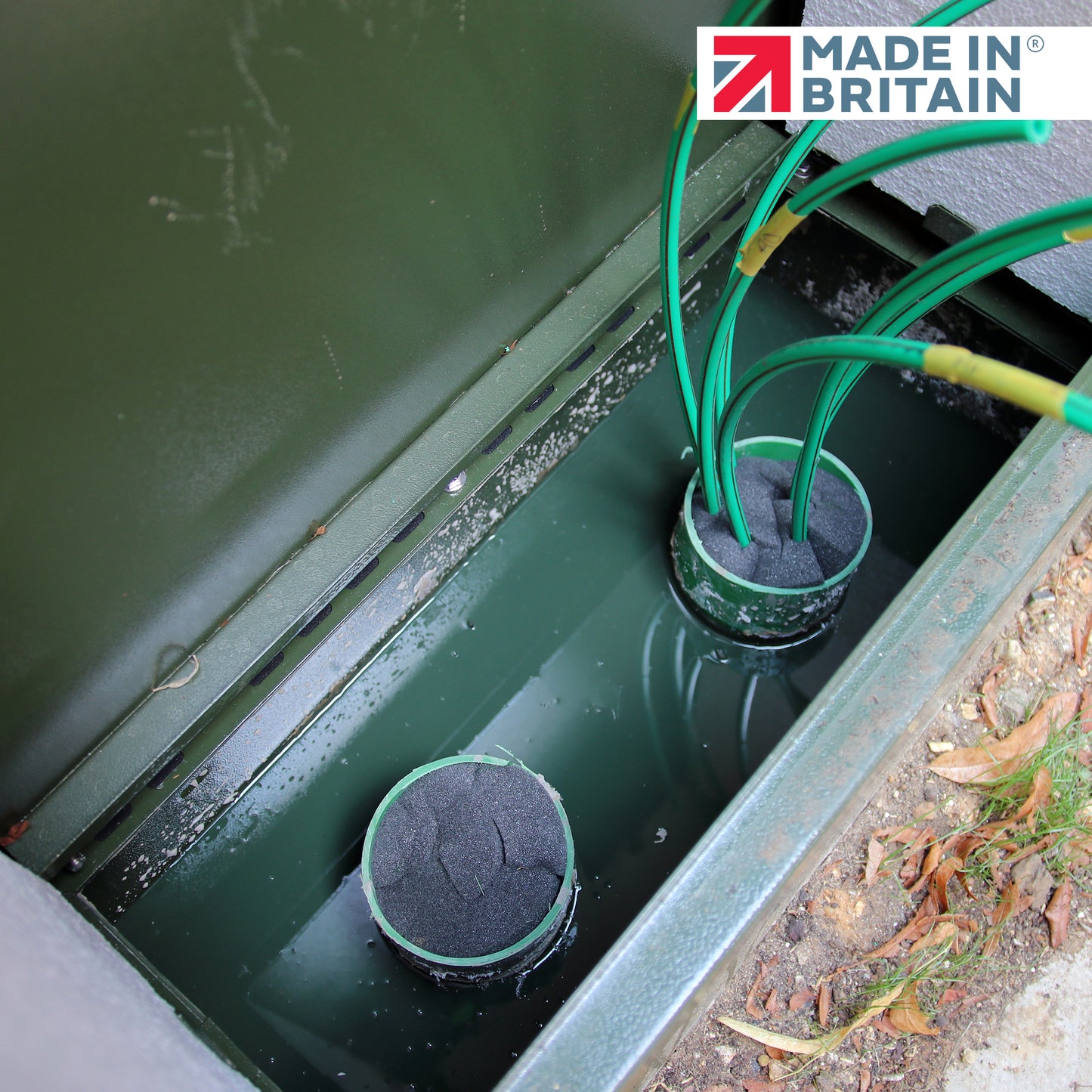 GreenStuff non-hazardous cabinet base sealant in use sealing cables within an underground telecom chamber, Made in Britain, providing water- and gas-tight protection for duct entries.