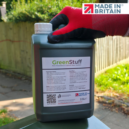 Container of Green Stuff with a gloved hand holding it, set against a garden background with 'Made in Britain' branding.
