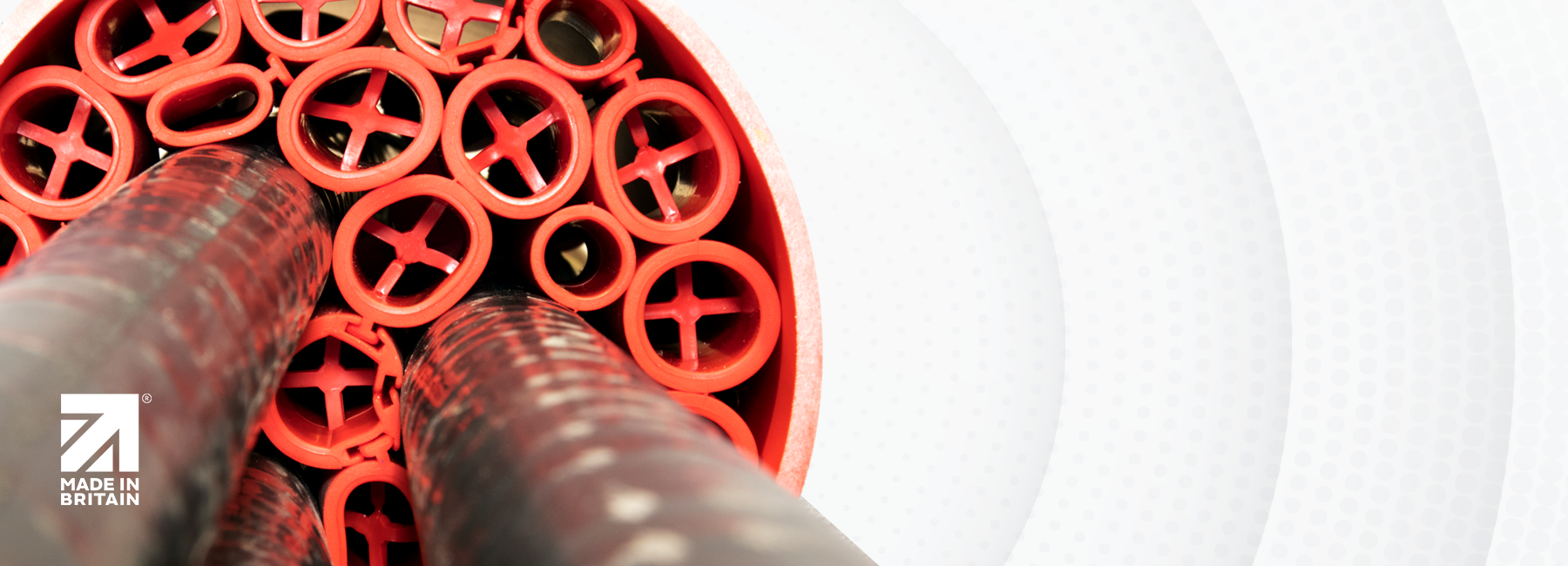 Red duct sealing modules with inserted cables, featuring the Made in Britain logo, representing Ductseal’s UK-manufactured cable duct sealing solutions.